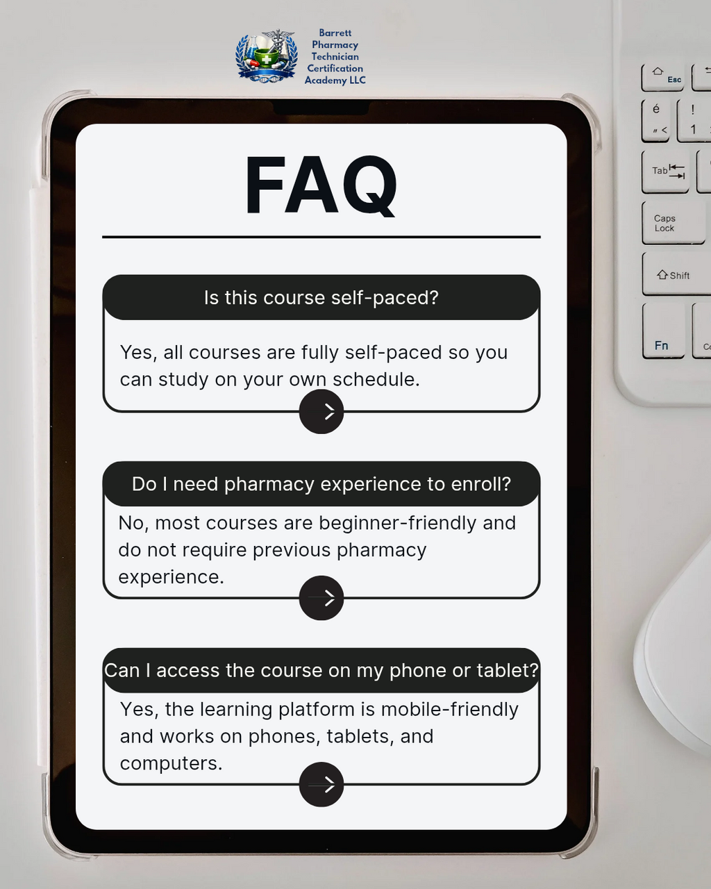 Tablet displaying FAQ section about a course on a desk with a keyboard.