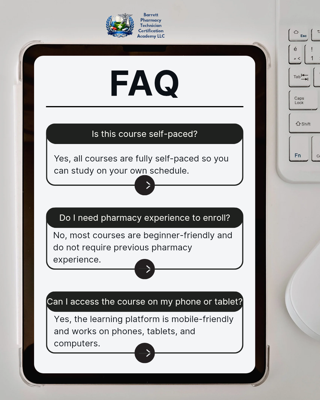 Tablet displaying FAQ section about a course on a desk with a keyboard.