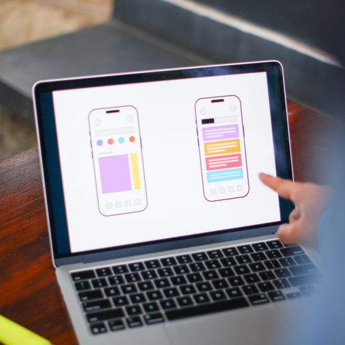 Person using a laptop with design software on screen